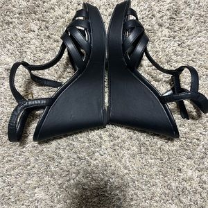 Size 8.5 black leather wedge never worn! These actually fit like a 7-7.5.
